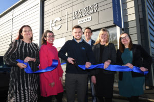 (from left) Bekki Phillips, In-Comms Training’s COO, Claire Critchell, Business Support at Telford & Wrekin Council, James Morgan, In-Comm’s apprentice of the year (cutting ribbon), Gareth Jones, MD of In-Comm Training, Georgina Barnard, MD of the Black Country and Marches Institute of Technology and Kathryn Jones, Head of Partnerships at Marches Local Enterprise Partnership