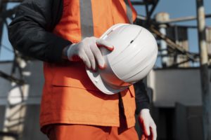 Close-up of a hand holding a safety helmet